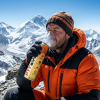 A mountain climber breathing oxygen from Fit&Wise Oxygen Can at mountain peak