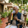 A senior citizen using Fit&Wise Portable Oxygen Can to breath better