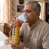 An elder person using Fit&Wise Portable Oxygen Can to take a breathe